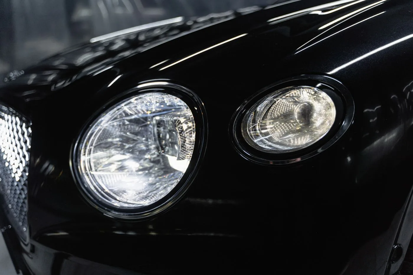 Clear round headlights on a polished black car